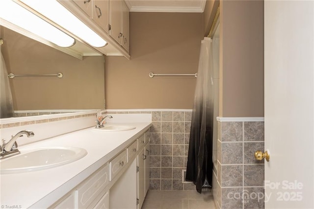 bathroom with ornamental molding, tile walls, tile patterned flooring, and vanity