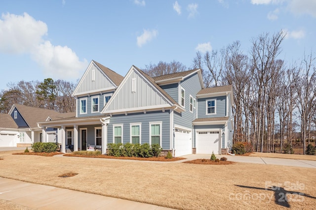 view of front facade featuring board and batten siding, covered porch, driveway, and an attached garage