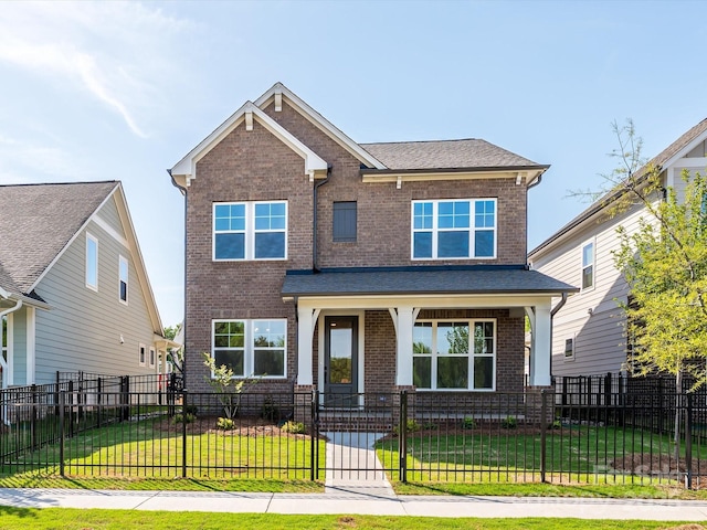 view of front of house featuring covered porch, a front yard, brick siding, and a fenced front yard