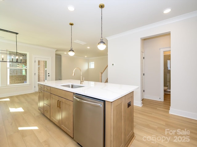 kitchen with a sink, ornamental molding, stainless steel dishwasher, and light wood-type flooring