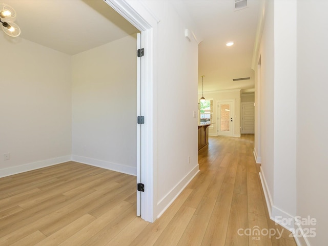 hallway with recessed lighting, visible vents, light wood-type flooring, and baseboards