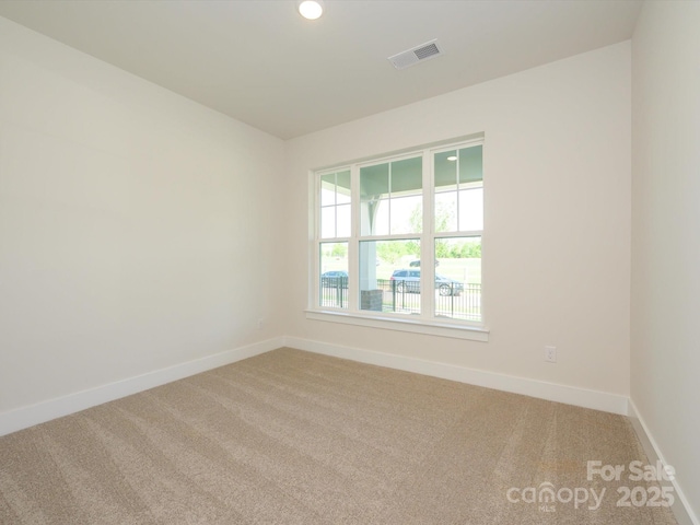 spare room with visible vents, baseboards, recessed lighting, and carpet flooring