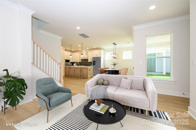 17021 Malone Ln, Mint Hill, NC 28227 - living area featuring stairs, light wood-style floors, ornamental molding, baseboards, and recessed lighting
