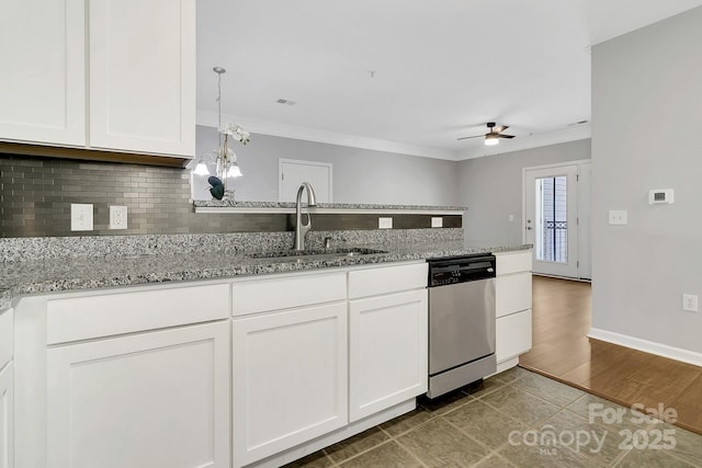 kitchen featuring crown molding, decorative backsplash, a sink, dishwasher, and a peninsula