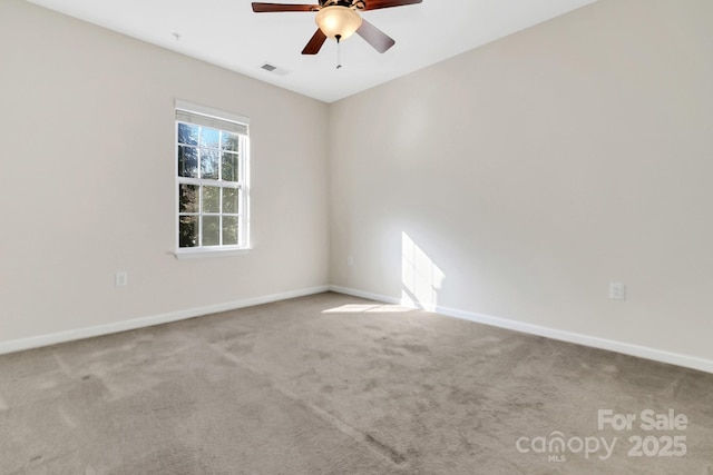 unfurnished room featuring a ceiling fan, baseboards, visible vents, and carpet flooring