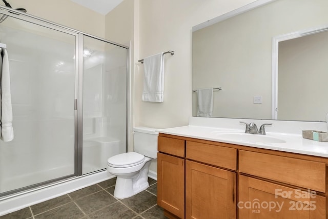 full bath with a stall shower, tile patterned flooring, vanity, and toilet