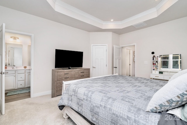 bedroom featuring light carpet, baseboards, a tray ceiling, and ornamental molding