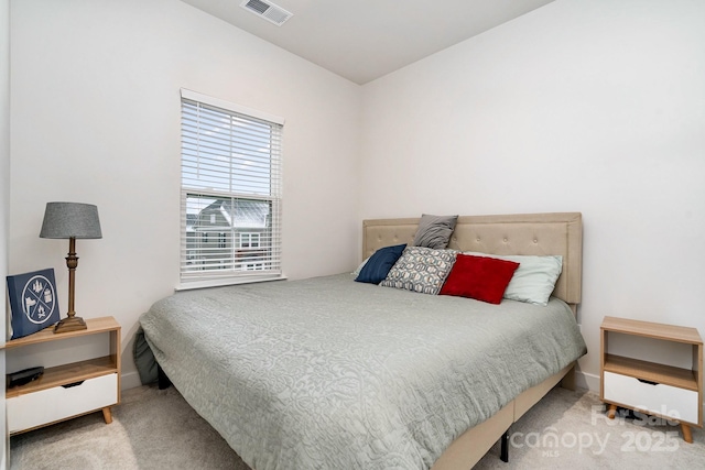 bedroom with baseboards, visible vents, and carpet flooring