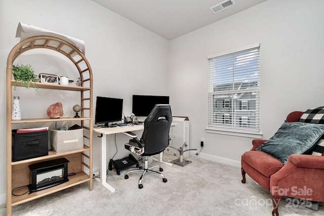 home office with light colored carpet, visible vents, and baseboards