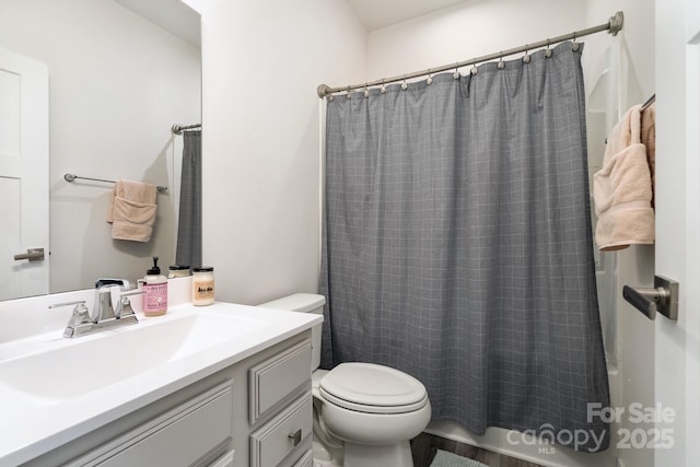 bathroom with toilet, shower / tub combo, and vanity