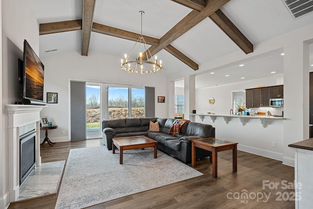 living room with baseboards, visible vents, dark wood finished floors, beam ceiling, and a high end fireplace