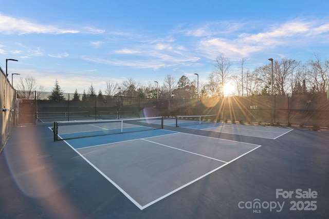 view of sport court featuring fence