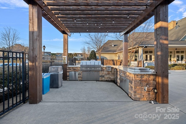 view of patio / terrace with area for grilling, an outdoor kitchen, fence, and a pergola