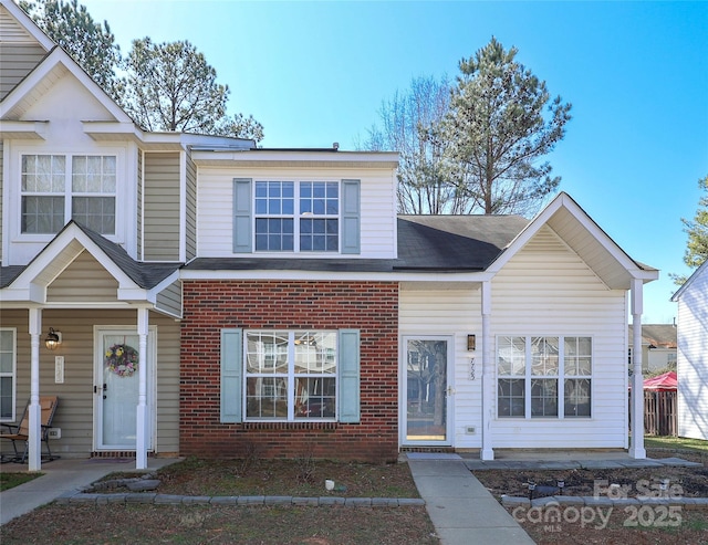 townhome / multi-family property with brick siding