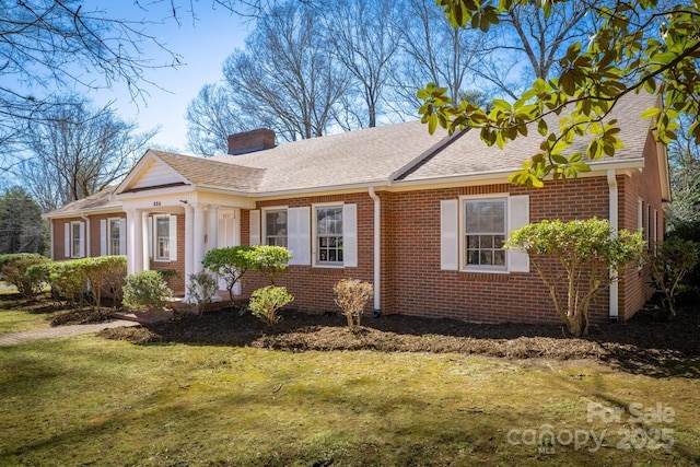 view of front of property featuring a front lawn, brick siding, roof with shingles, and a chimney