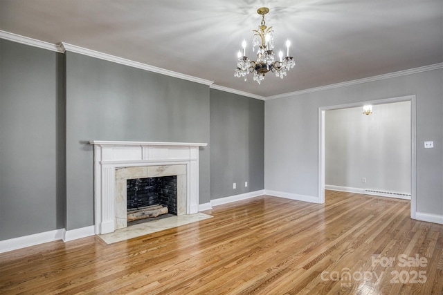 unfurnished living room with ornamental molding, wood finished floors, baseboards, and a premium fireplace