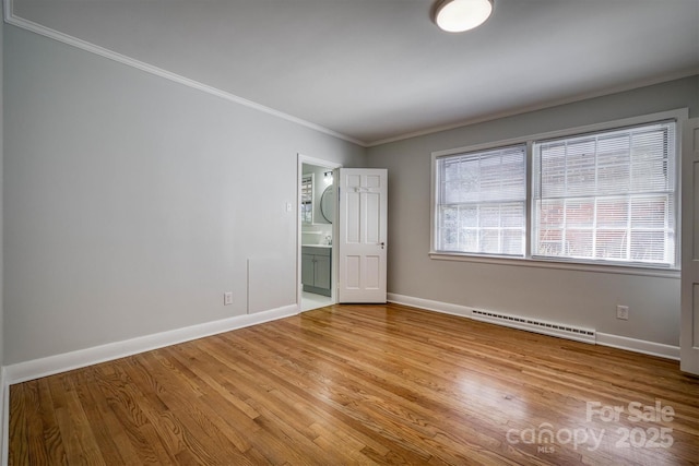 unfurnished bedroom featuring light wood finished floors, baseboards, ensuite bath, ornamental molding, and baseboard heating