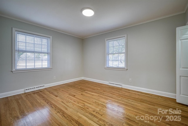 unfurnished room featuring ornamental molding, visible vents, baseboards, and wood finished floors