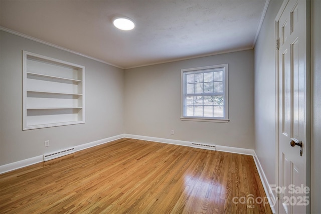 unfurnished room with visible vents, built in features, light wood-style flooring, and baseboards