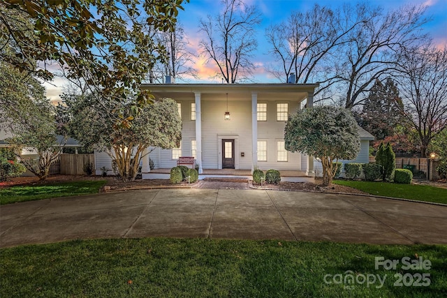 view of front of home with fence and a porch