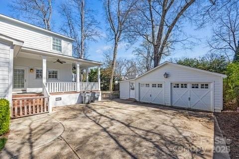 view of home's exterior featuring an outbuilding, a porch, and a detached garage