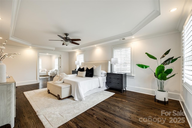 bedroom featuring baseboards, a raised ceiling, dark wood-style floors, crown molding, and recessed lighting