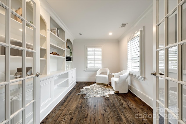 living area featuring ornamental molding, baseboards, visible vents, and dark wood-type flooring