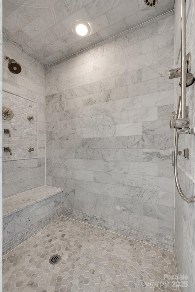 full bath featuring a tile shower