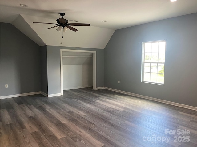 additional living space featuring lofted ceiling, recessed lighting, dark wood-type flooring, a ceiling fan, and baseboards