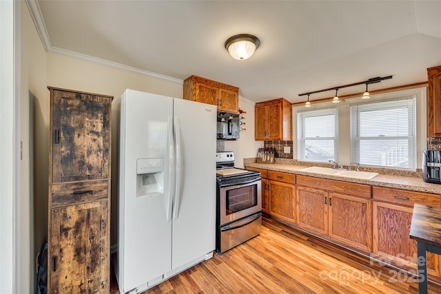 kitchen featuring brown cabinetry, stainless steel range with electric cooktop, a sink, white fridge with ice dispenser, and black microwave