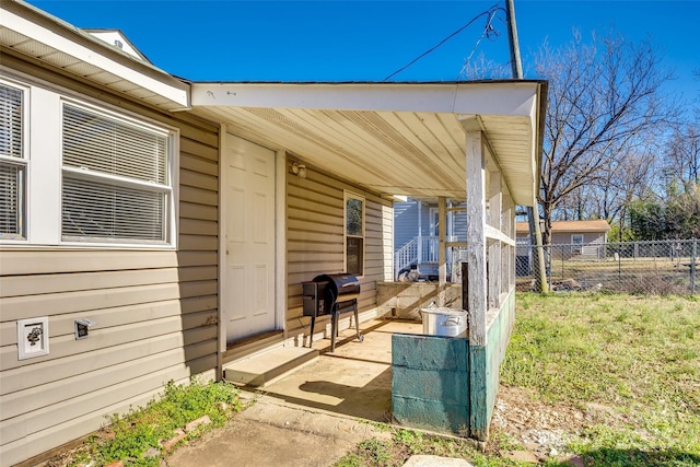 view of patio with covered porch, a grill, and fence