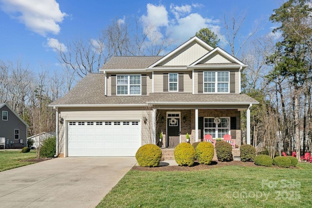 craftsman-style house featuring a front lawn, covered porch, a shingled roof, and concrete driveway