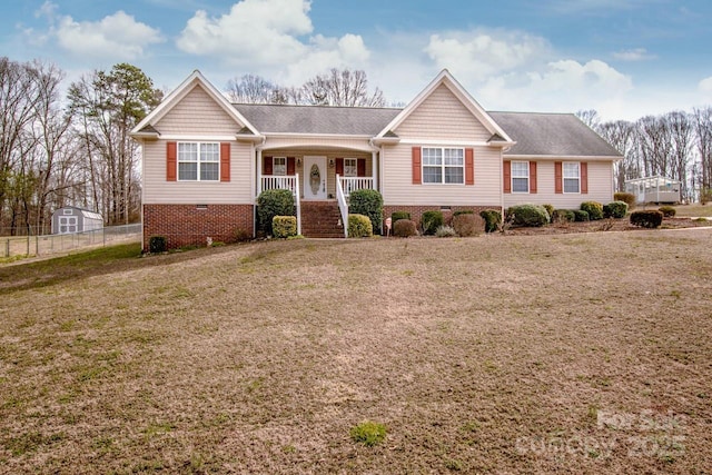 ranch-style home featuring crawl space, fence, a porch, and a front yard