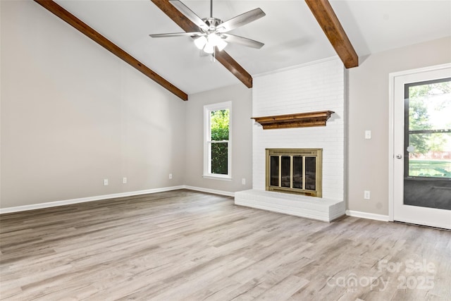 unfurnished living room featuring baseboards, a fireplace, a wealth of natural light, and light wood-style floors