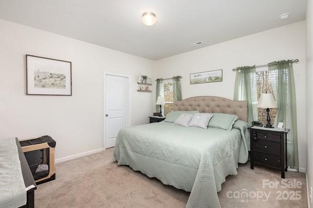 carpeted bedroom with baseboards