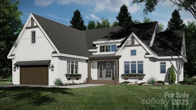 view of front of property with an attached garage, a shingled roof, and a front yard