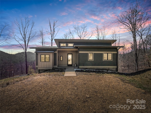 view of front of property with board and batten siding and a mountain view