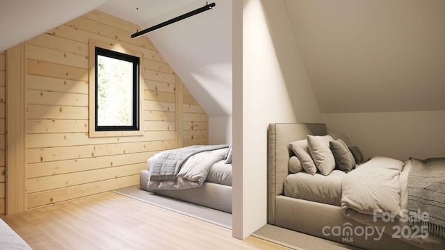 bedroom featuring light hardwood / wood-style flooring, wood walls, and lofted ceiling