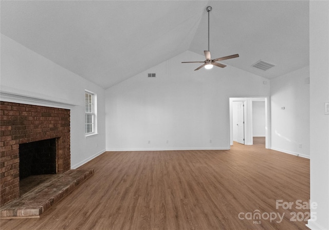 unfurnished living room featuring ceiling fan, visible vents, a fireplace, and wood finished floors