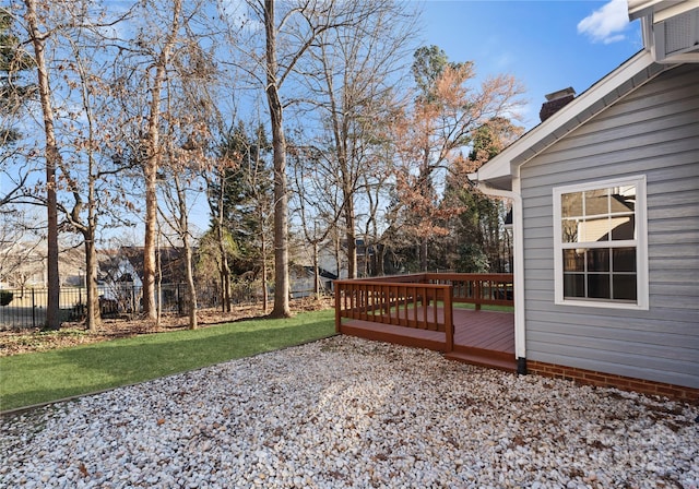 deck with a yard and fence