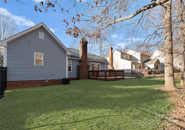 rear view of house with a chimney, crawl space, a yard, fence, and a wooden deck