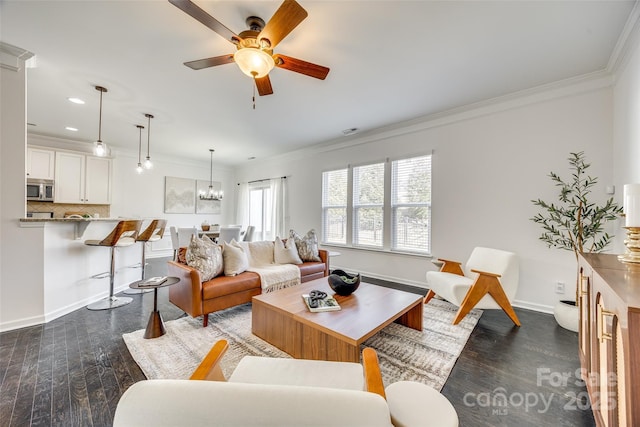 living room featuring baseboards, dark wood-style flooring, ceiling fan with notable chandelier, and crown molding