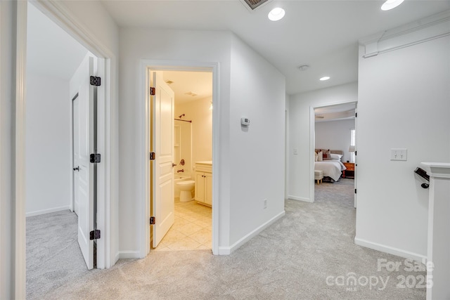 hallway featuring recessed lighting, light carpet, visible vents, and baseboards