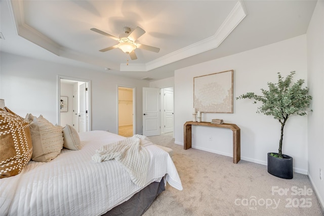 bedroom with light carpet, baseboards, a tray ceiling, and ornamental molding