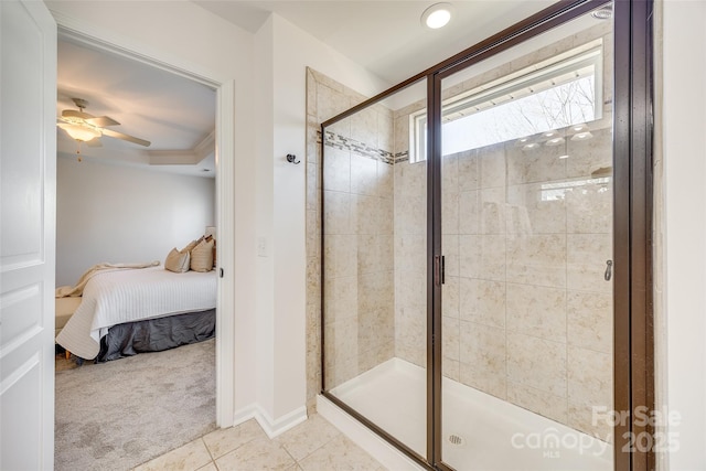 bathroom with a ceiling fan, a stall shower, connected bathroom, baseboards, and tile patterned floors