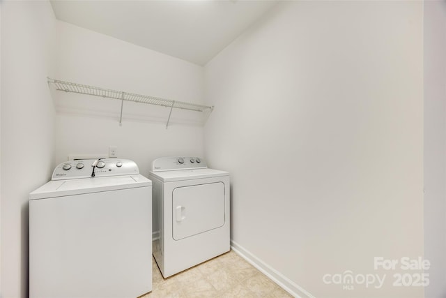 washroom featuring laundry area, light floors, independent washer and dryer, and baseboards