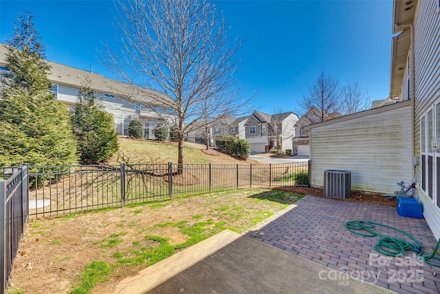 view of yard with central AC, a residential view, a patio area, and a fenced backyard