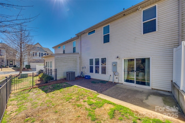 back of property featuring a patio, a lawn, a fenced backyard, and central air condition unit