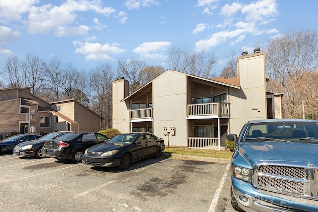 view of building exterior featuring uncovered parking