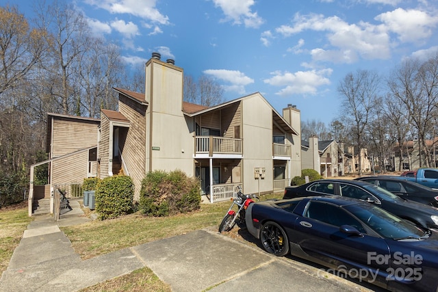 view of property featuring a residential view and uncovered parking